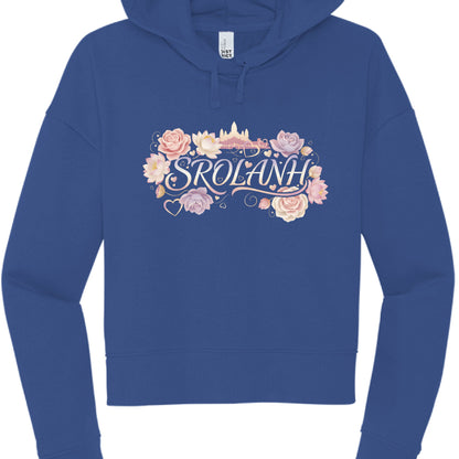 "Srolanh" (Black & Royal Blue Hoodies): These cropped hoodies feature the word "SROLANH" (Khmer for "love") in a delicate, iridescent script.

The designs are framed by an assortment of pink roses, lotuses, and small floating heart icons.

A soft gold silhouette of Angkor Wat sits behind the text on the black hoodie, while the blue hoodie features a similar floral and temple backdrop.
