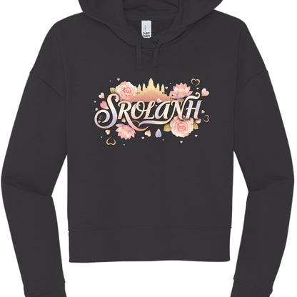 "Srolanh" (Black Hoodie): This black cropped hoodie features the word "SROLANH" (meaning "love" in Khmer) in a soft, iridescent script. The design is accented by:

A silhouette of Angkor Wat in a soft gold tone.

An arrangement of pink roses, lotuses, and floating heart icons.