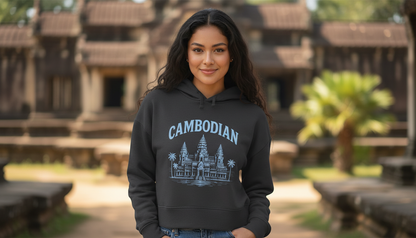 Woman wearing a hoodie with 'Cambodian' and Angkor Wat design in front of a temple.