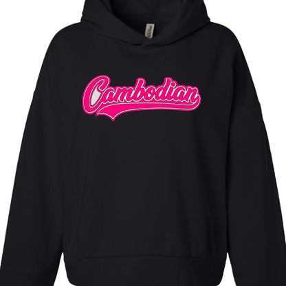 Text Content: The word "Cambodian" is printed centrally on the chest.

Typography: The text uses a script, cursive font with a retro or athletic feel.

Color Palette: The lettering is white, accented with a vibrant pink outline and a matching pink swoosh underline.

Style: The design mimics a classic "varsity" or sports logo aesthetic.