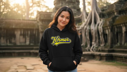 Woman wearing a black hoodie with 'Khmer' printed on it, standing in front of ancient temple ruins.