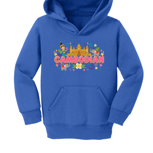 Royal Blue Hoodie
Typography: Shares the same rounded pink "CAMBODIAN" bubble lettering as the red version.

Imagery: Features a golden Angkor Wat as the centerpiece, flanked by a character in traditional dress and several small elephants.

Decorations: The graphic is accented with yellow and white flowers, green leaves, and colorful swirls.

Garment: A royal blue youth-sized hoodie with a classic front pocket.