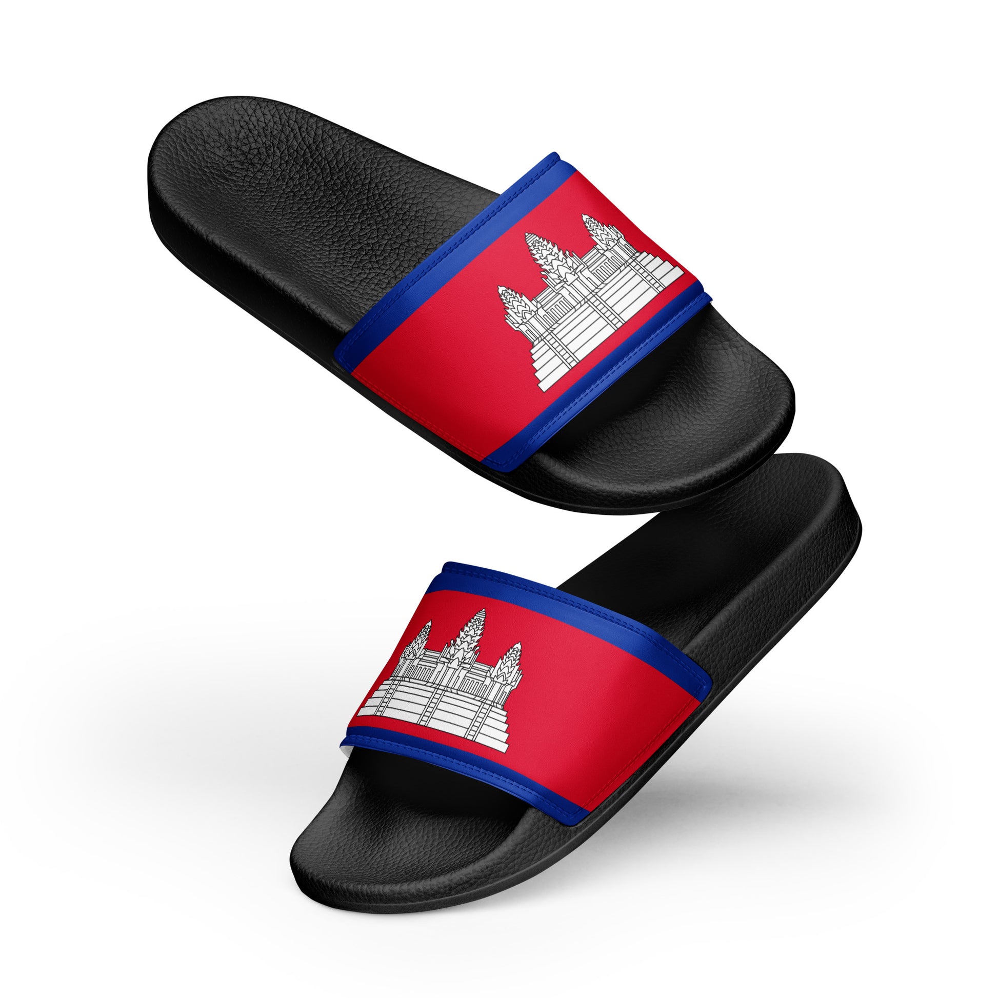 The image shows a pair of black slide sandals floating against a clean, white background.

The most prominent feature is the Cambodian national flag printed across the wide straps of the sandals. The design includes:

Top and bottom blue stripes bordering the strap.

A central red field featuring the white, three-towered silhouette of Angkor Wat.

The sandals themselves have a textured, leather-like grain on the footbed and the straps. They are positioned at an angle, with one slightly above the other, givi